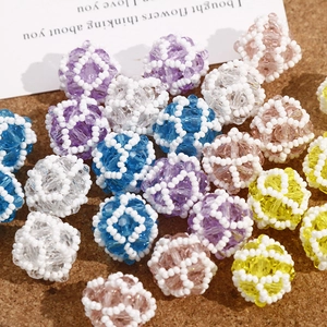 Detail of colorful woven crystal bead balls for DIY jewelry crafting on cork