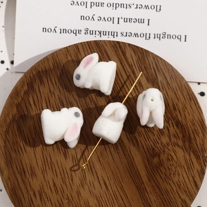 Cute white flocked rabbit beads for DIY jewelry making displayed on a wooden tray