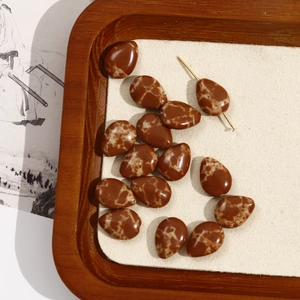 Detailed view of brown teardrop stone beads with retro marble texture for jewelry DIY