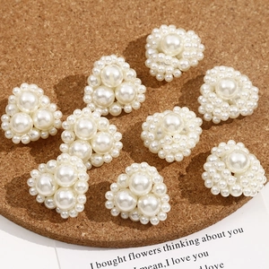 Detailed view of heart-shaped pearl accessories and beads for DIY jewelry making