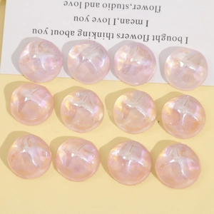 Macro detail of 18mm iridescent pink resin cabochons with starry glitter wave texture