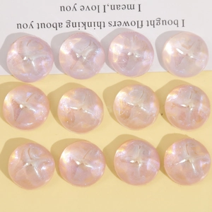 Close-up of 18mm round resin glitter cabochons with pink-purple pearlescent effect