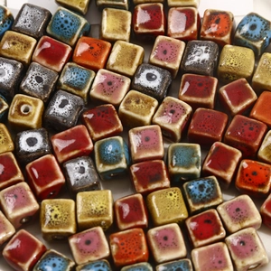 Macro shot of colorful cube ceramic beads with speckled glaze for DIY jewelry making
