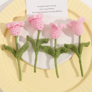 Handmade crochet pink tulip flower bouquet on decorative tray with aesthetic card