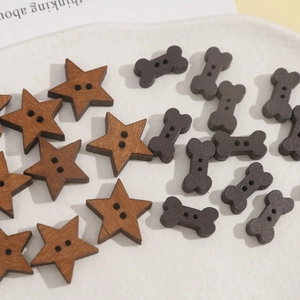 Detailed view of star and bone shaped wooden buttons with two holes for DIY sewing
