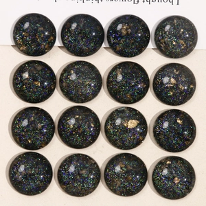Detailed view of 16 circular starry sky resin cabochons with colorful glitter for DIY crafts