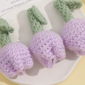 Close-up of handmade crochet lavender tulip flowers with detailed knitted texture
