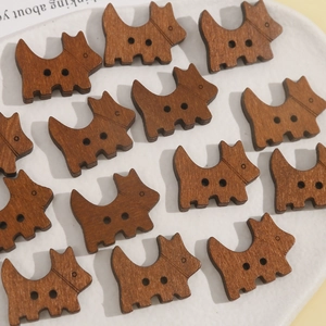 Macro view of brown wooden Scottish Terrier dog buttons with two sewing holes