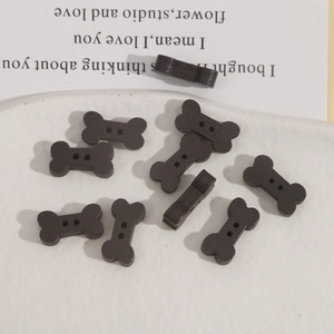 Brown bone-shaped wooden buttons with two holes on a decorative background for DIY crafts