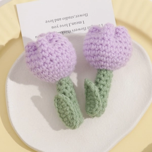 Handmade knitted lavender tulip brooches with green leaves on decorative plates