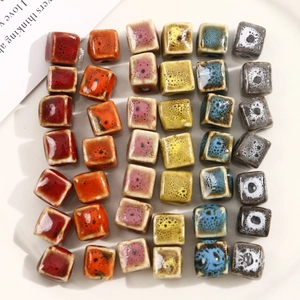 Macro view of colorful square ceramic beads with spotted glaze texture for DIY jewelry