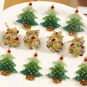 Handmade Christmas tree and gift bag charms in a white ceramic dish for holiday DIY decor