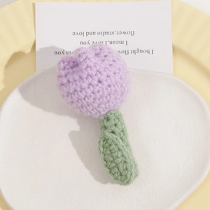 Detail of handcrafted crochet light purple tulip brooch made of soft yarn wool