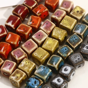 Macro detail of colorful square ceramic beads with glazed texture for jewelry making