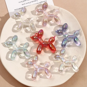 Detailed macro of gradient iridescent acrylic balloon dog pendants with a glossy AB coating
