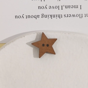 Macro detail of star-shaped brown wood button with dual holes for DIY craft accessories