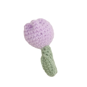 Handmade crochet light purple tulip brooch with green leaves on a white background