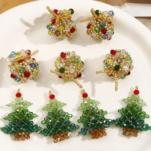 Detailed view of handmade beaded colorful Christmas tree and lucky bag charm pendants