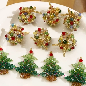 Detailed view of handmade beaded Christmas tree and colorful sphere pendants for DIY jewelry
