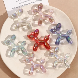 Macro view of iridescent acrylic balloon dog pendants with aurora finish and top loop