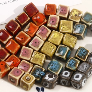 Macro view of square ceramic beads with variegated kiln glaze for DIY jewelry making