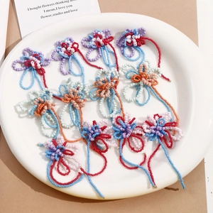Macro detail of handmade colorful beaded flower charms with intricate woven layers