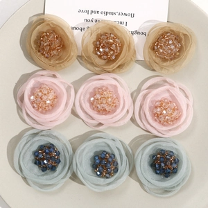 Macro detail of handmade mesh flower accessories with crystal beads for DIY hairpins