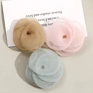Three-piece set of mesh flower accessories in gold, pink and blue showing the back side