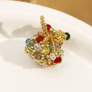 Macro shot of a handmade beaded apple pendant with colorful faceted crystal beads