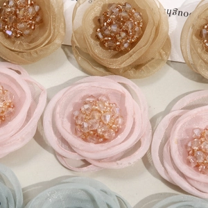Mesh flower embellishments with crystal centers in champagne, pink and blue shades