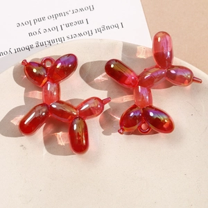 Macro shot of 3D gradient acrylic balloon dog charms with metallic luster on display