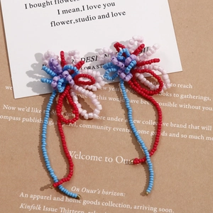 Macro detail of handmade beaded flower tassels with colorful seed beads in boho style