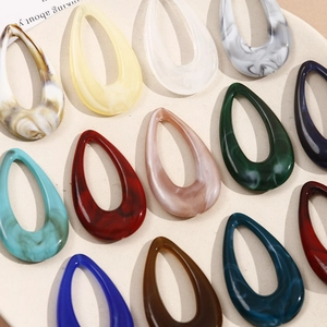 Detailed close-up of marble pattern acrylic drop pendants in various colors for DIY earrings