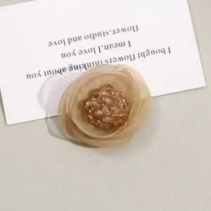 Detail of champagne mesh flower with crystal bead center for DIY hair accessories