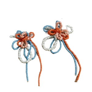 Handmade bohemian beaded flower earrings with colorful tassels and light blue petals