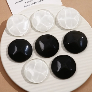 Macro detail of 40mm round water ripple resin charms for DIY earrings and phone cases