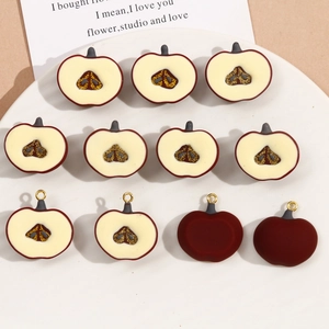Detailed view of dark red resin apple charms with glittery cores for DIY jewelry making