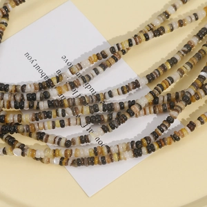 Detailed close-up of 3mm natural shell heishi beads in earth tones for jewelry making