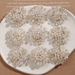 Detailed macro view of handmade crystal flower petals with milky beads and gold wire