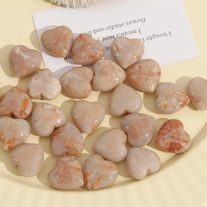 Macro detail of 20mm marble textured resin heart beads for DIY jewelry making