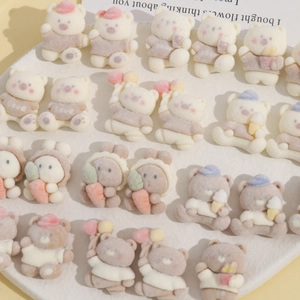 Detailed close-up of flocked cartoon bear and rabbit DIY resin charms in cream tones