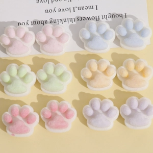 Macro view of 12 colorful flocked cat paw resin charms for DIY hair accessories