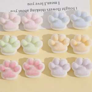 Detailed macro view of colorful plush cat paw resin charms for DIY hair accessories