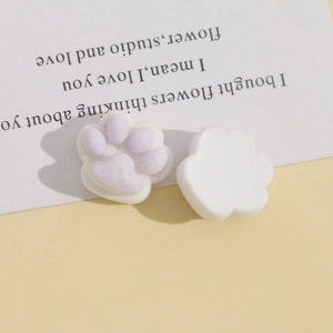Detail of purple flocked cat paw resin patch for DIY crafts showing front and back textures