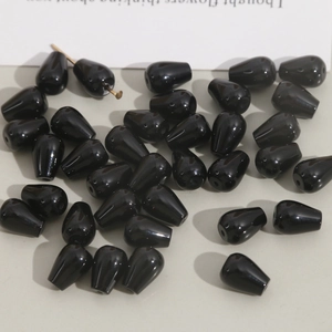 Polished black teardrop beads made of natural onyx for DIY jewelry making and earrings