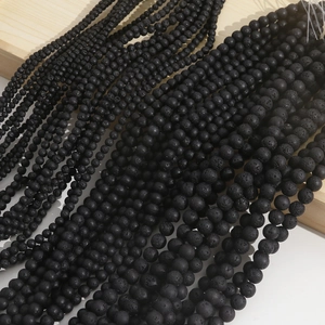 Macro shot of black lava stone beads showing porous textures for DIY jewelry