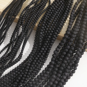 Macro shot of assorted black lava rock beads in multiple sizes for DIY jewelry making