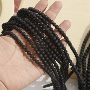 Detailed close-up of natural porous black lava stone beads for DIY jewelry making