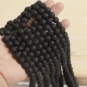 Close-up of black volcanic lava stone beads showing natural porous texture for DIY jewelry