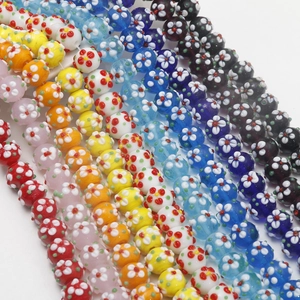 Detailed view of colorful millefiori glass beads with floral patterns for DIY jewelry